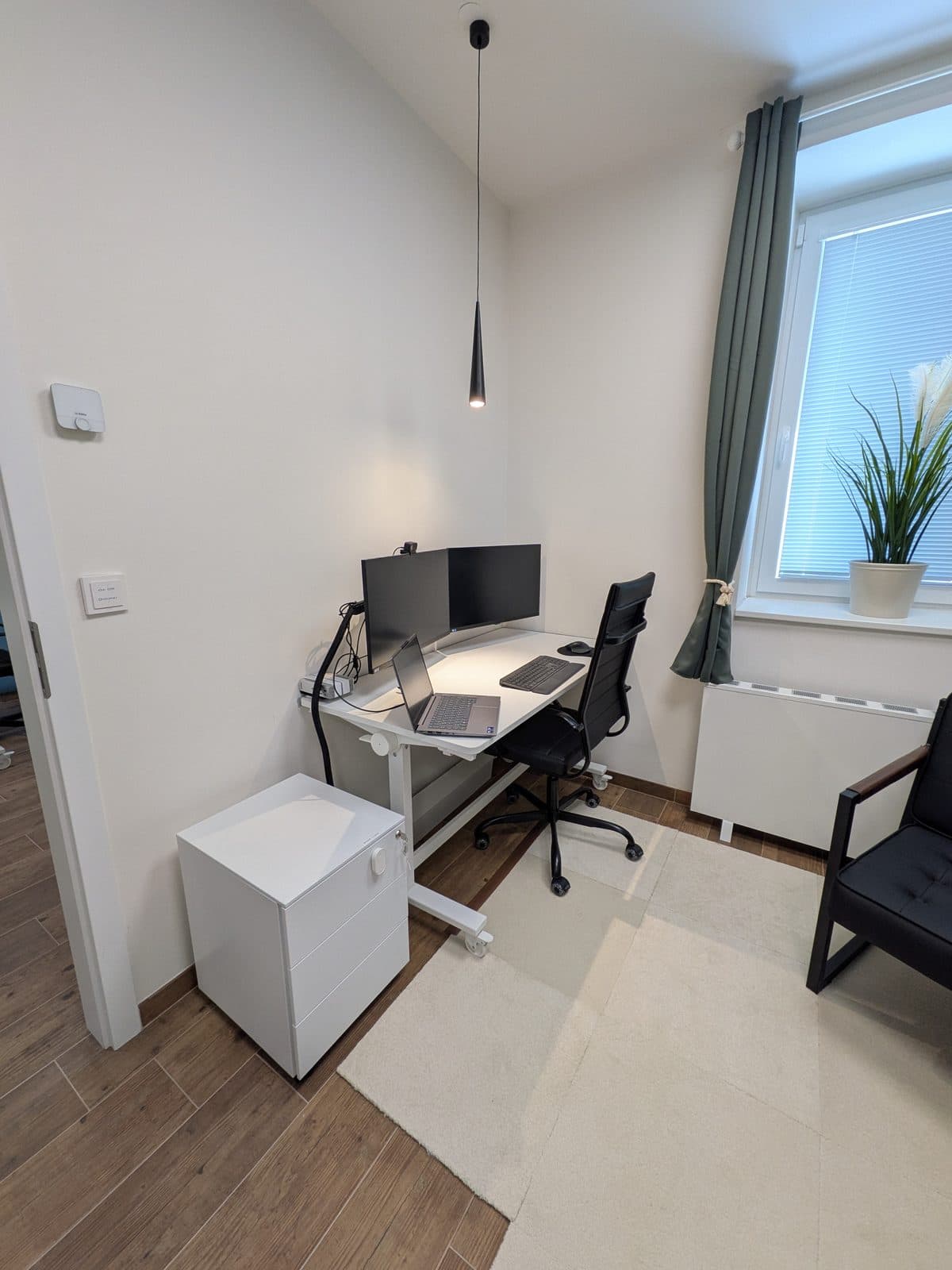 Pracovní místo v místnosti 2 se dvěma monitory a oknem